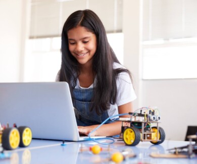 Female Student Building And Programing Robot Vehicle In After School Computer Coding Class